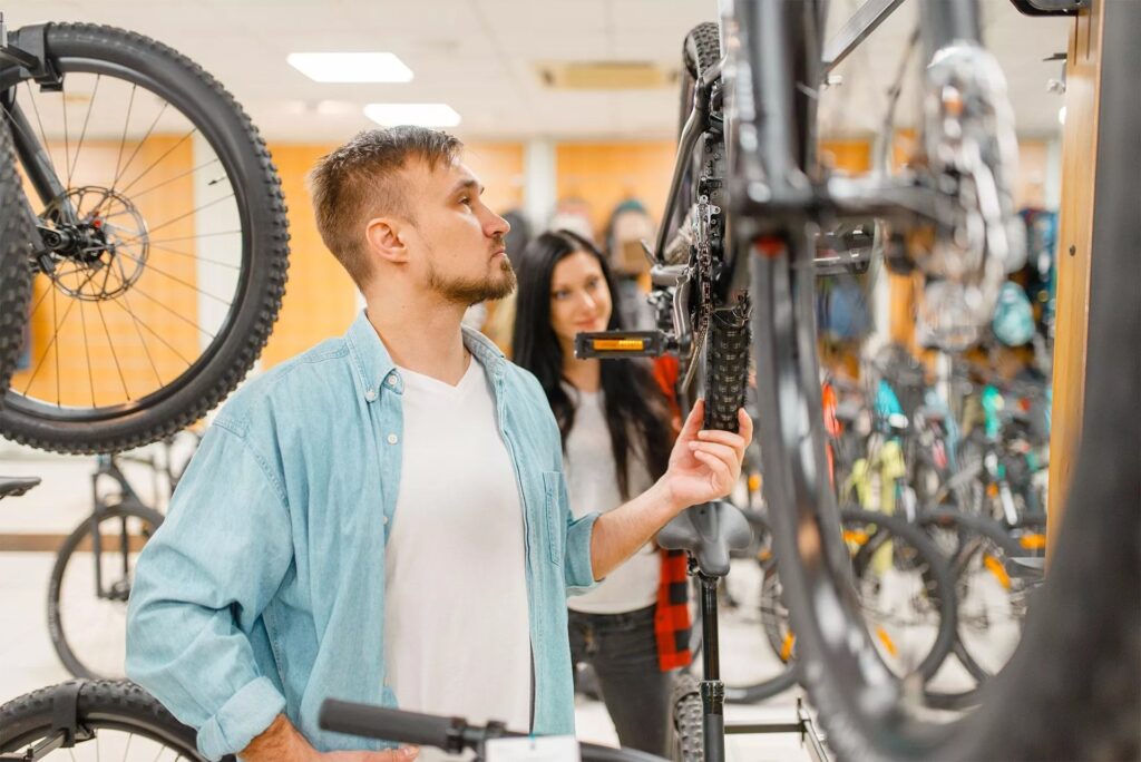 Man Checks Bicycle Disk Breaks Shopping